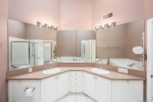 a bathroom with a double vanity sink and mirror
