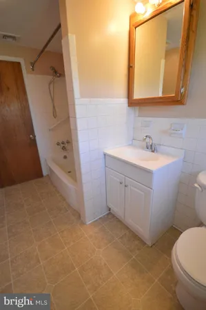 a bathroom with a sink a toilet and mirror