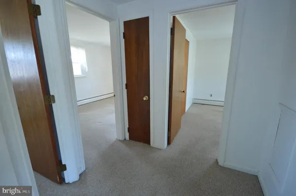 an empty room with mirror and entrance