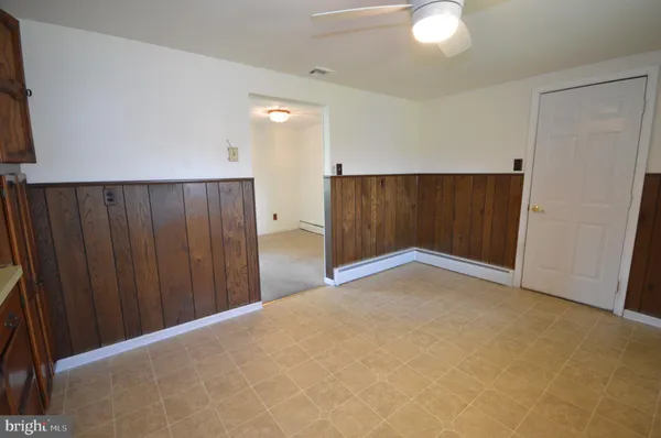 a view of an empty room with wooden door