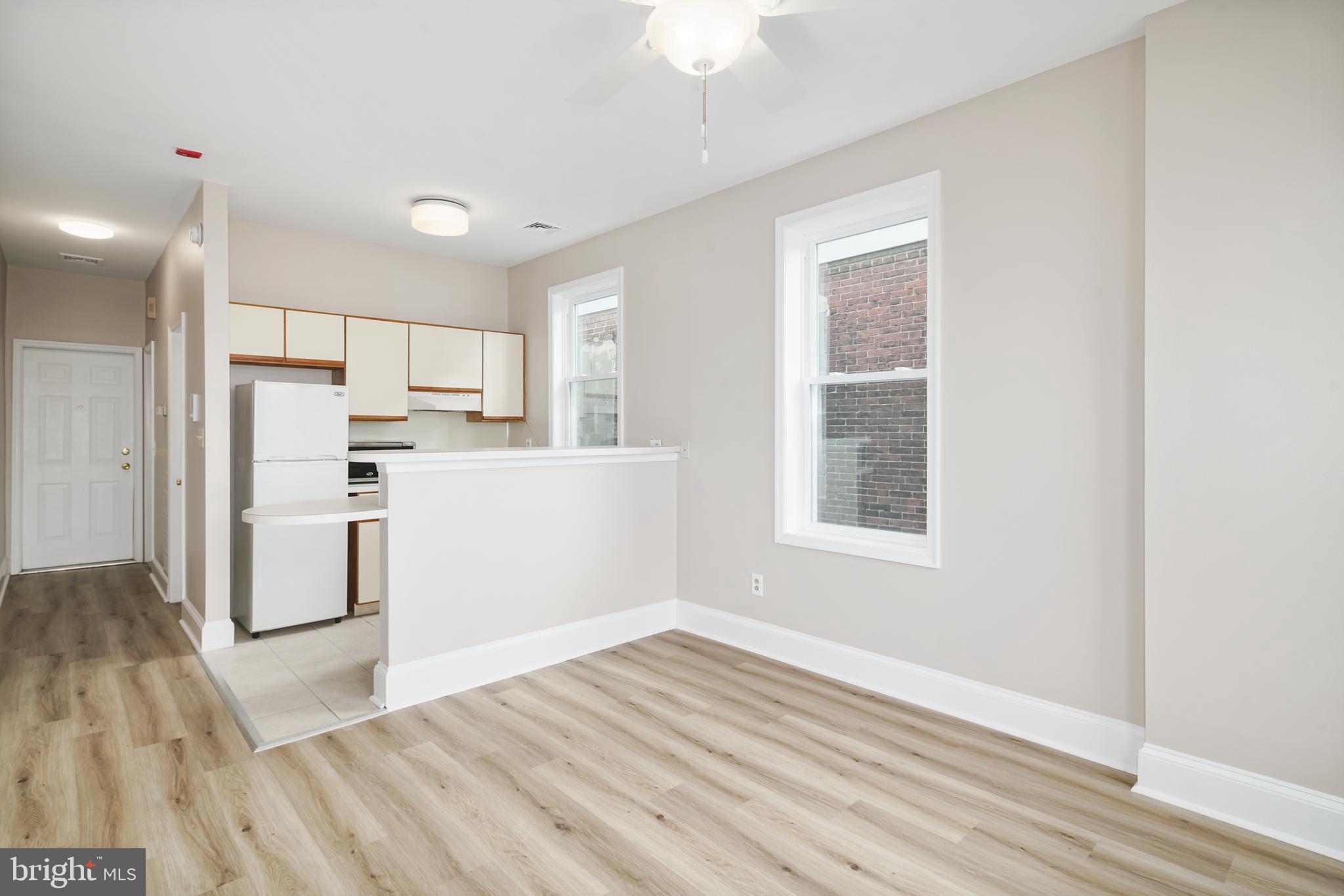 2338 South Broad Street Philadelphia, PA 19145 - Photo 2 of 7 a view of a kitchen with wooden floor and a window