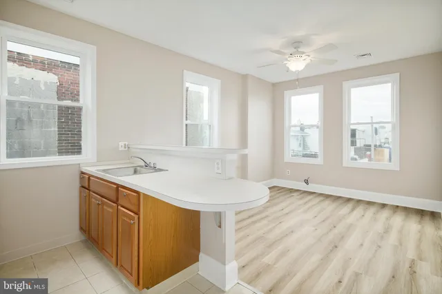 a kitchen with a sink a stove and a refrigerator