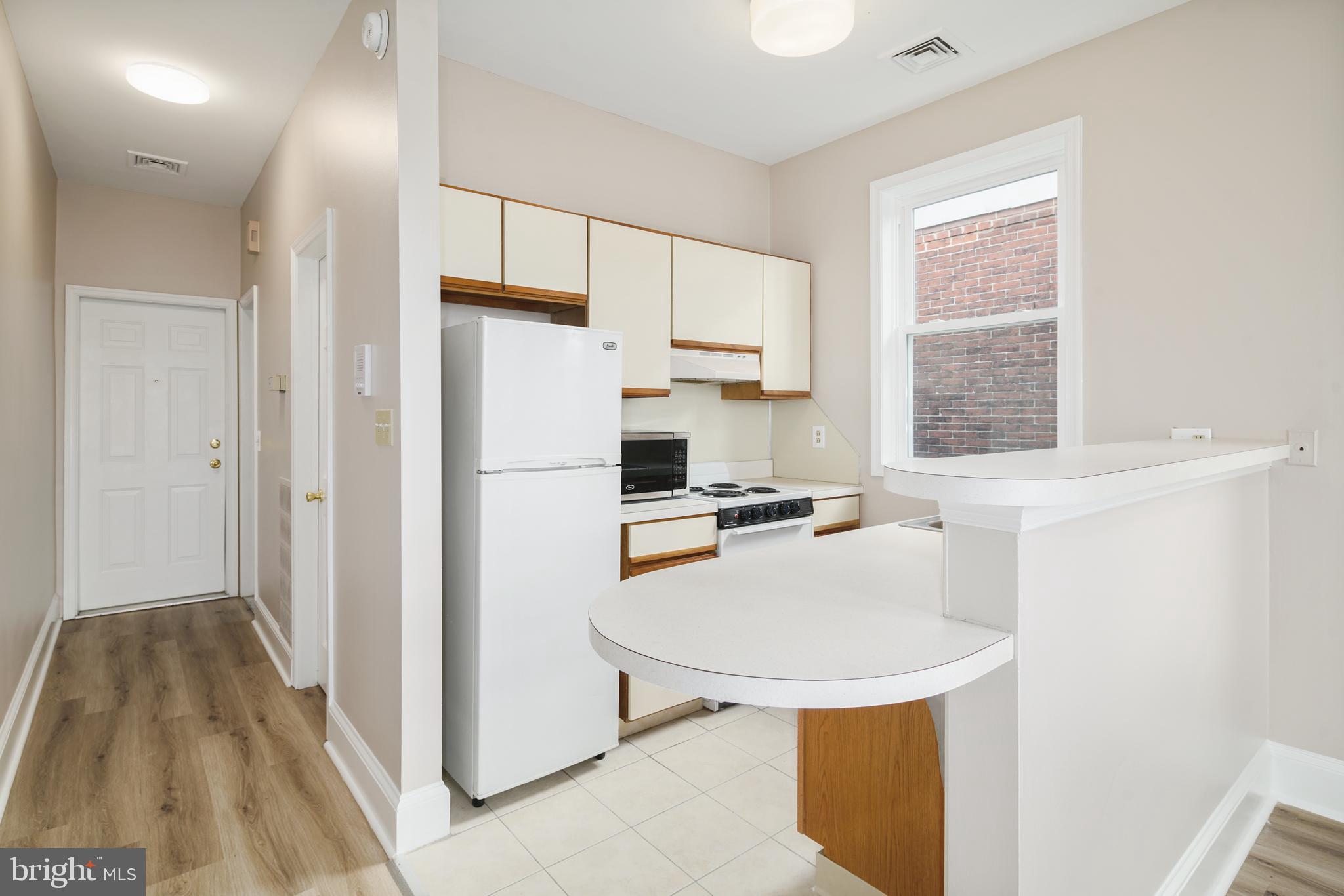 2338 South Broad Street Philadelphia, PA 19145 - Photo 5 of 7 a kitchen with a refrigerator a sink and a stove