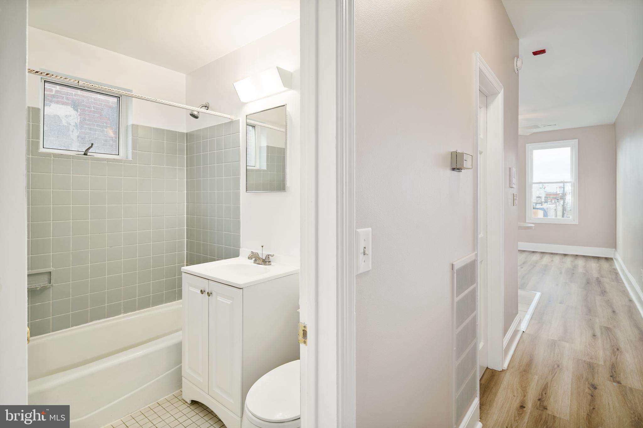 2338 South Broad Street Philadelphia, PA 19145 - Photo 6 of 7 a bathroom with a sink toilet and shower