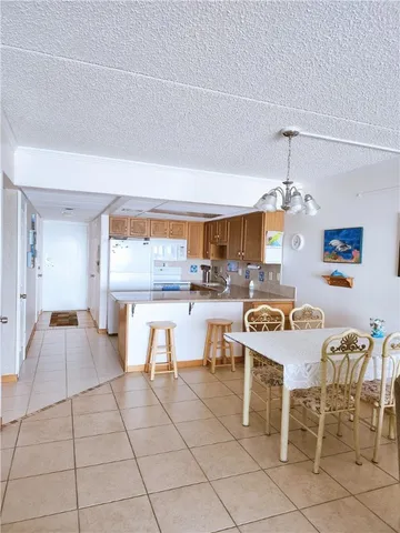 a kitchen with stainless steel appliances kitchen island granite countertop a table and chairs in it