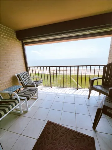 a view of a chairs and table in the balcony