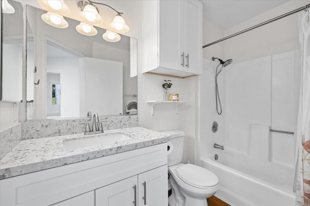 8166 Lemon Grove Way, Unit B Lemon Grove, CA 91945 - Photo 18 of 38 a bathroom with a granite countertop sink a toilet and a mirror
