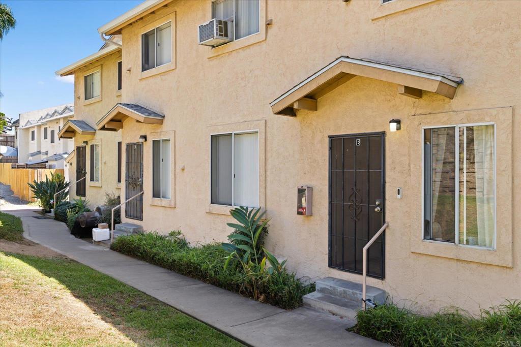 8166 Lemon Grove Way, Unit B Lemon Grove, CA 91945 - Photo 26 of 38 a front view of a house with a yard