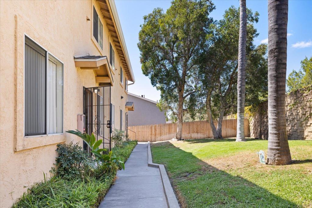 8166 Lemon Grove Way, Unit B Lemon Grove, CA 91945 - Photo 27 of 38 a view of a house with brick walls plants and large tree