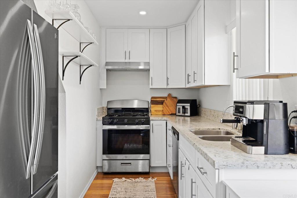 8166 Lemon Grove Way, Unit B Lemon Grove, CA 91945 - Photo 8 of 38 a kitchen with a stove a refrigerator and a sink