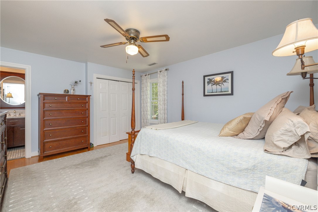 5421 Hunters Trail Road Goochland, VA 23063 - Photo 27 of 50 a bedroom with a bed and a chandelier