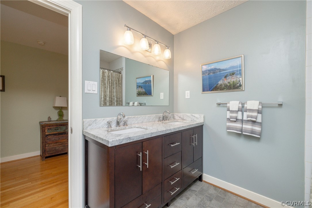 5421 Hunters Trail Road Goochland, VA 23063 - Photo 32 of 50 a bathroom with a granite countertop sink mirror and vanity