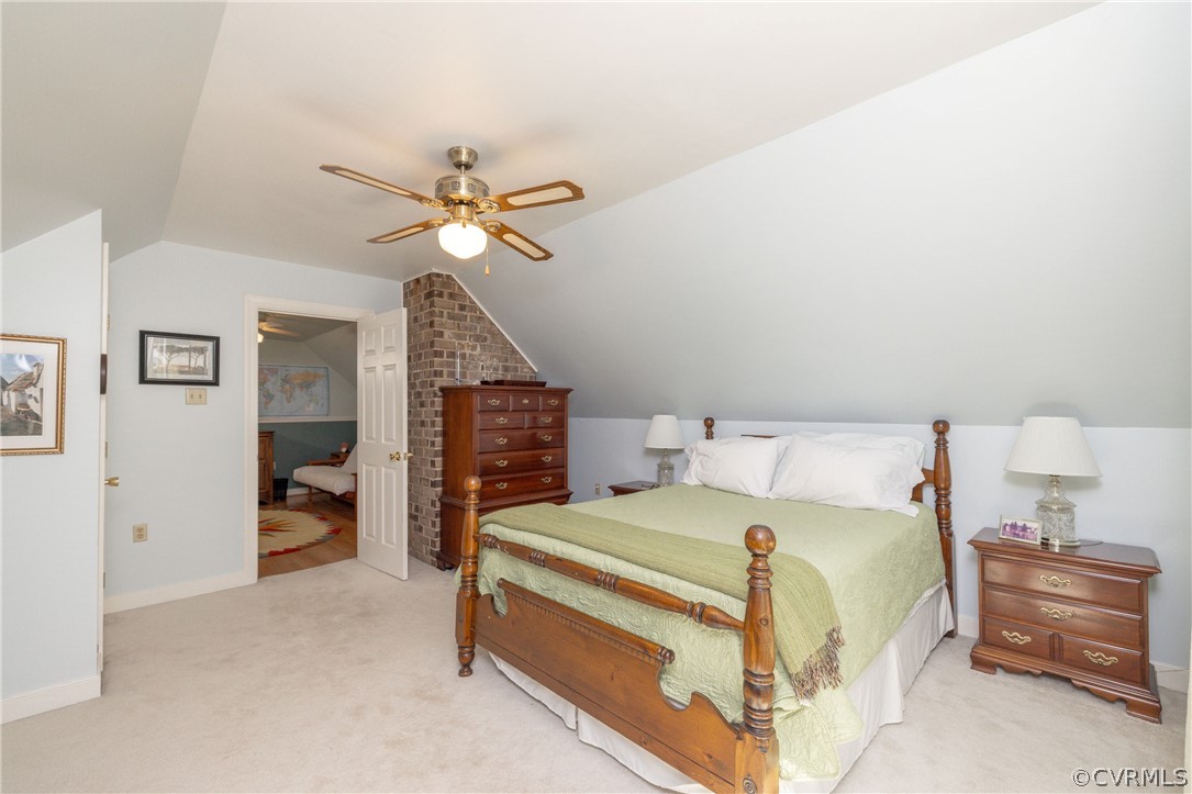 5421 Hunters Trail Road Goochland, VA 23063 - Photo 40 of 50 a bedroom with a bed and a chandelier