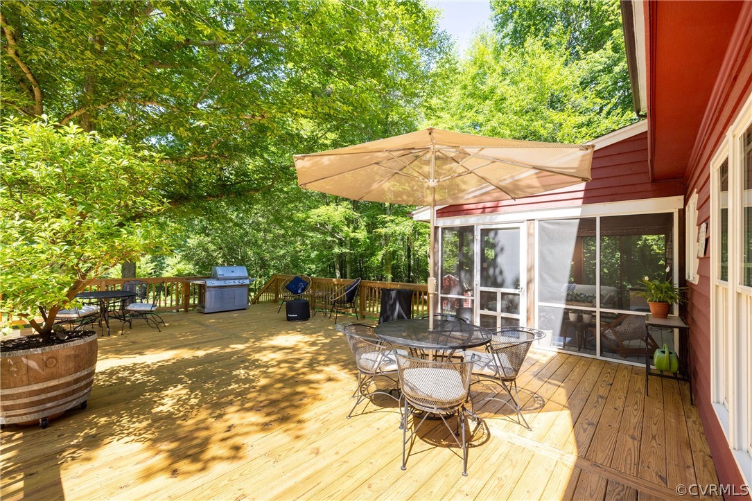 5421 Hunters Trail Road Goochland, VA 23063 - Photo 43 of 50 a view of a patio with table and chairs potted plants with wooden floor and plants