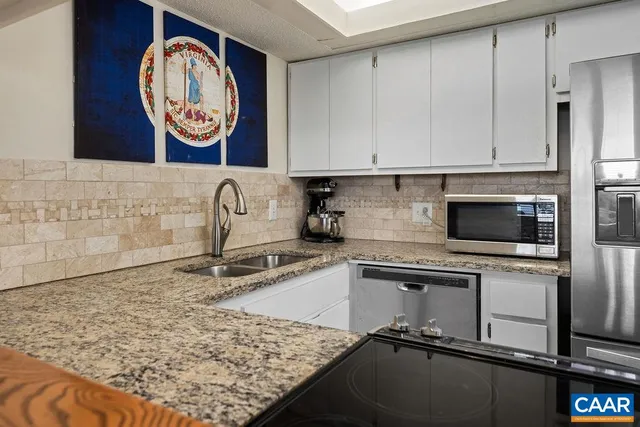 a kitchen with a sink cabinets and stove