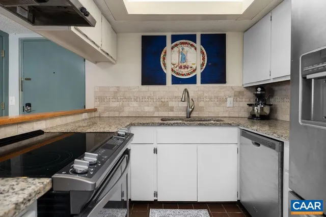 a kitchen with a sink and a stove