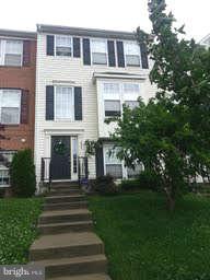 881 Middle River Road Baltimore, MD 21220 - Photo 1 of 3 a front view of a house with a garden
