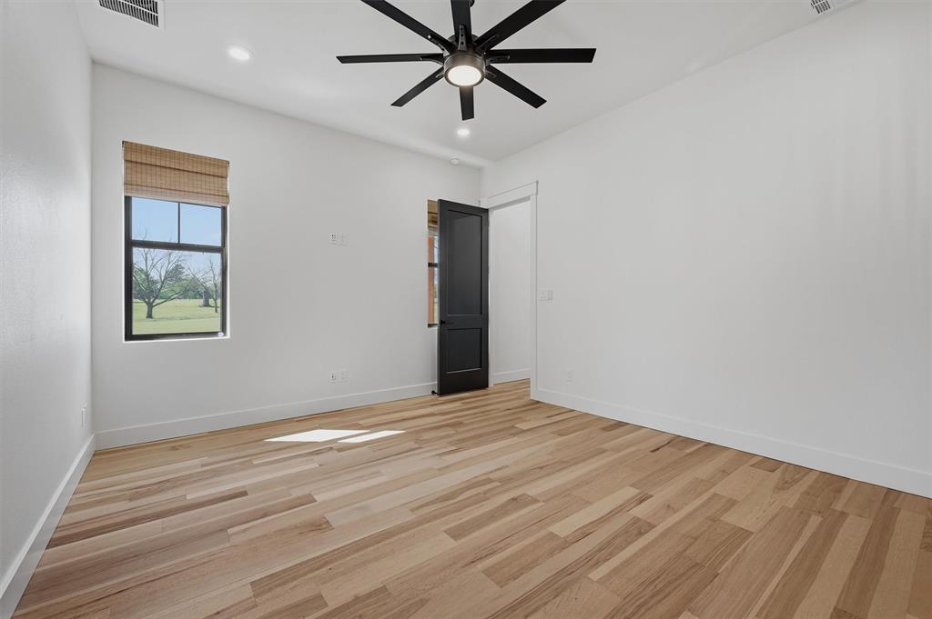 1805 Arthur Road Denison, TX 75021 - Photo 16 of 40 a view of an empty room with window and wooden floor