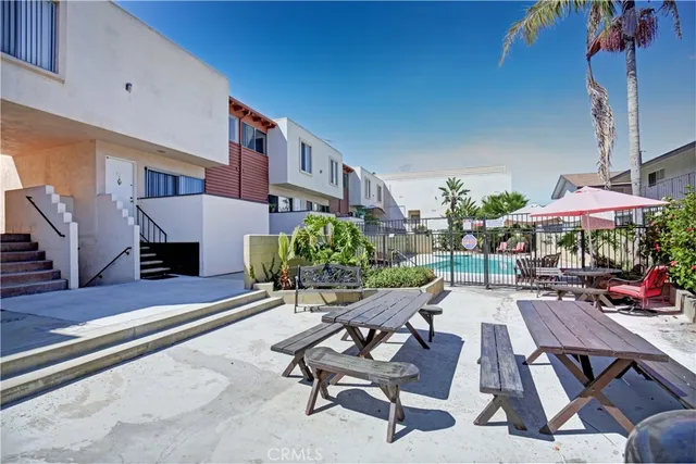 a view of a patio with a table and chairs under an umbrella