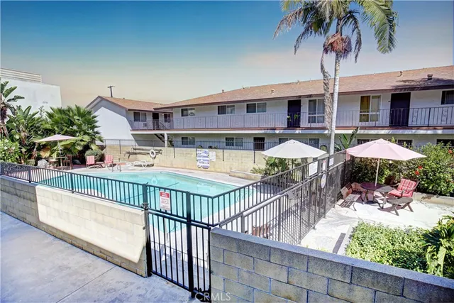 a view of a house with backyard and sitting area