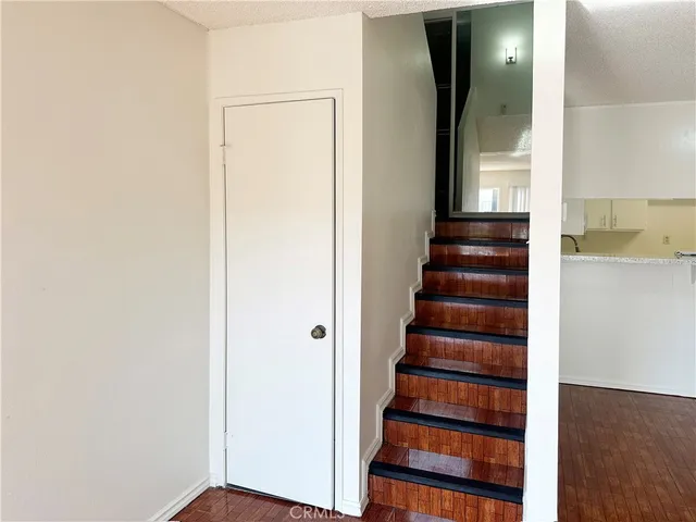 a view of entryway with wooden floor and stairs