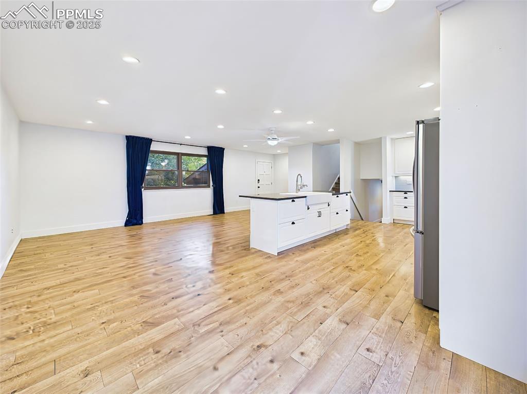 5040 Escapardo Way Colorado Springs, CO 80917 - Photo 16 of 50 a big room with wooden floor and natural light