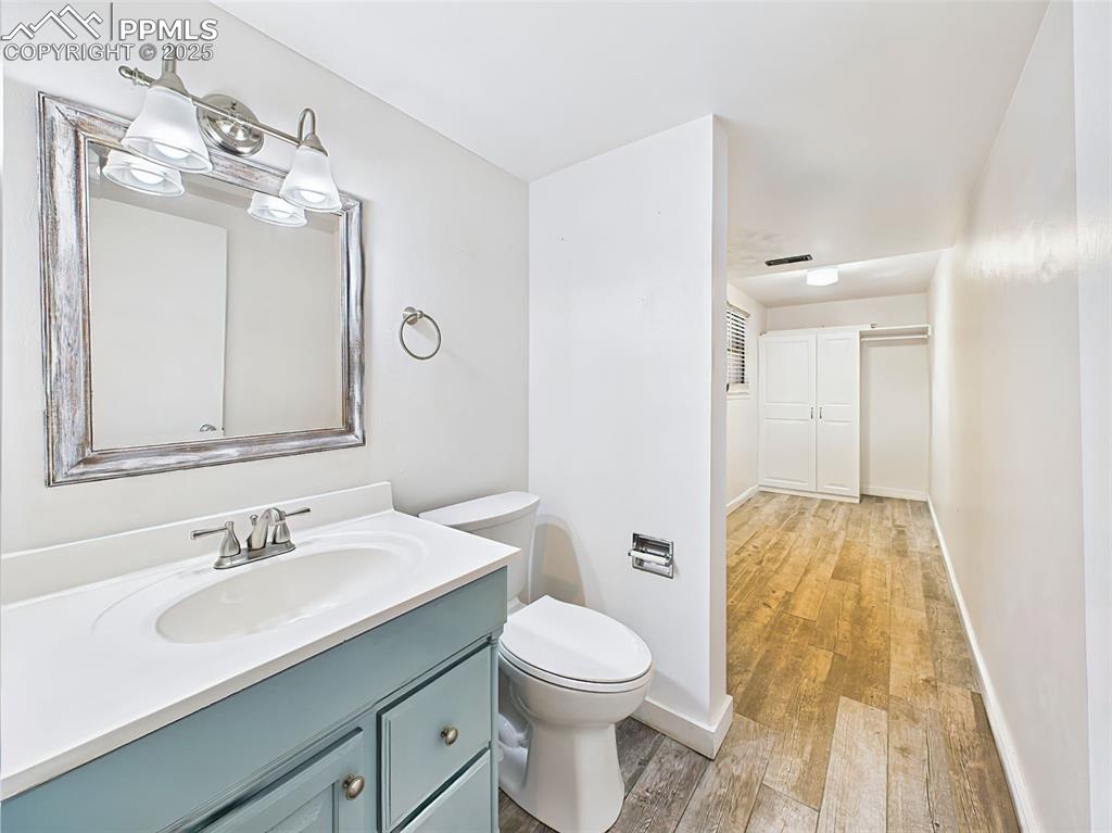 5040 Escapardo Way Colorado Springs, CO 80917 - Photo 26 of 50 a bathroom with a sink a toilet and mirror