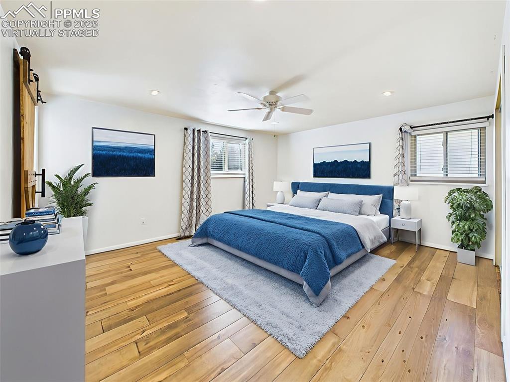5040 Escapardo Way Colorado Springs, CO 80917 - Photo 29 of 50 a bedroom with a large bed potted plant and a window