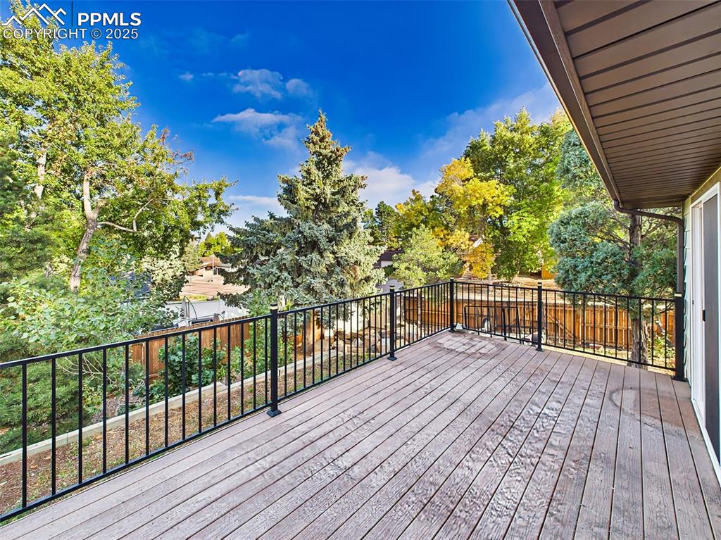 5040 Escapardo Way Colorado Springs, CO 80917 - Photo 45 of 50 a view of balcony with wooden floor and fence