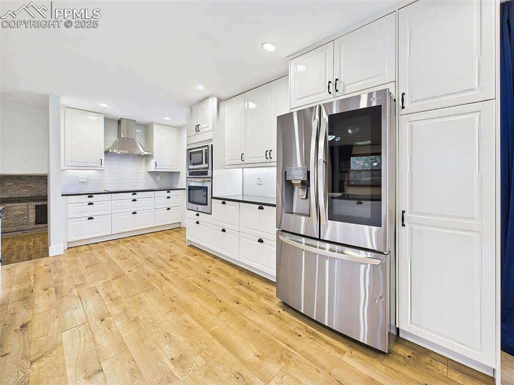 5040 Escapardo Way Colorado Springs, CO 80917 - Photo 8 of 50 a large kitchen with cabinets and stainless steel appliances