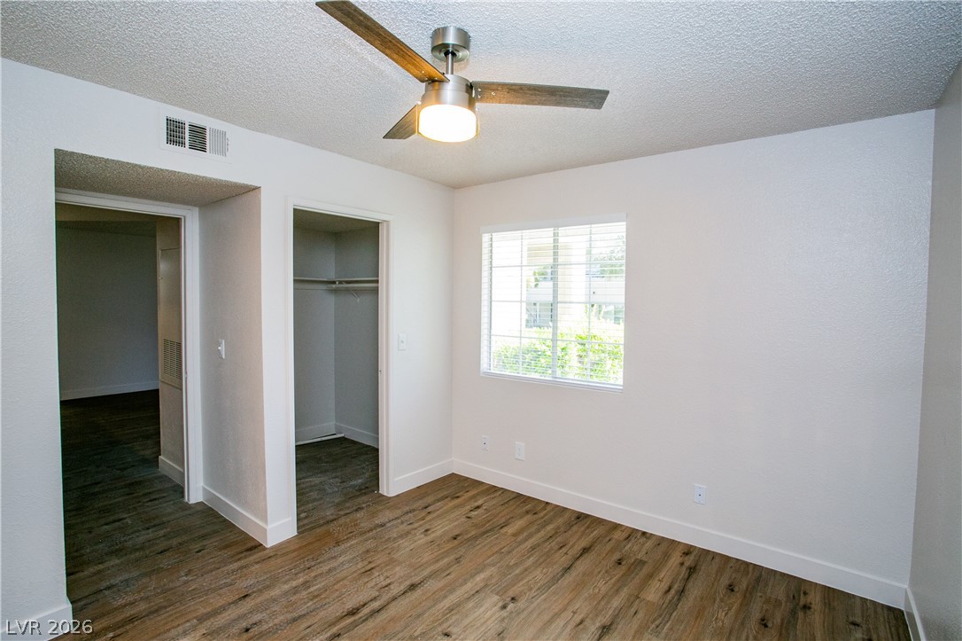 6750 Del Rey Avenue, Unit 108 Las Vegas, NV 89146 - Photo 4 of 11 This spacious bedroom offers ample natural light and durable flooring, perfect for comfortable living.