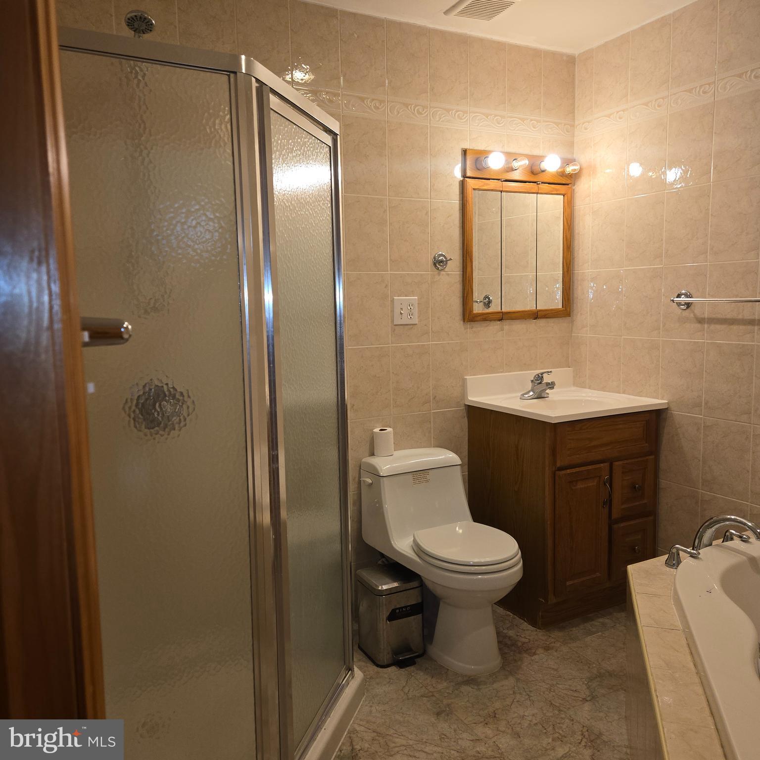 3505 Templar Road Randallstown, MD 21133 - Photo 17 of 40 a bathroom with a toilet sink and shower