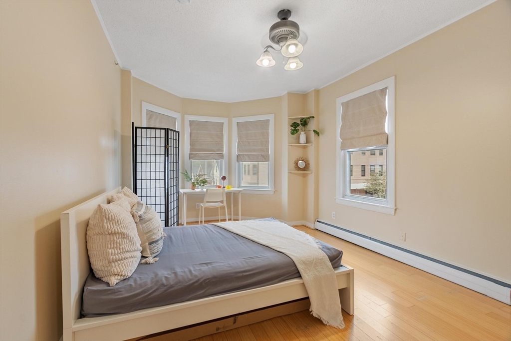 793 Main Street, Unit 1 Malden, MA 02148 - Photo 5 of 8 a bedroom with a large bed and a window