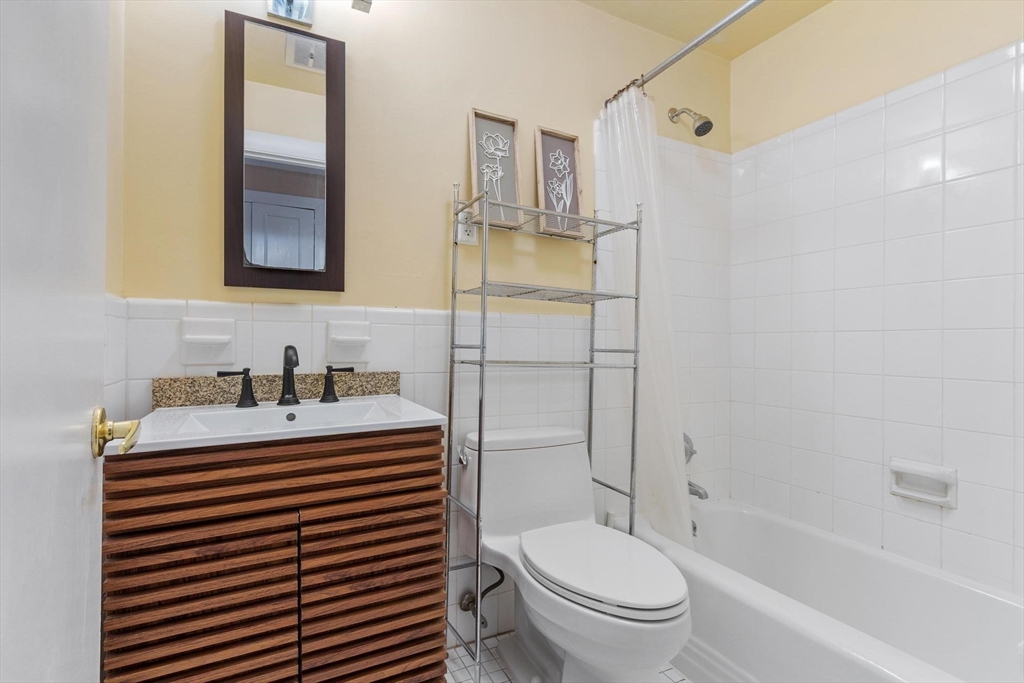 793 Main Street, Unit 1 Malden, MA 02148 - Photo 6 of 8 a bathroom with a sink toilet and shower