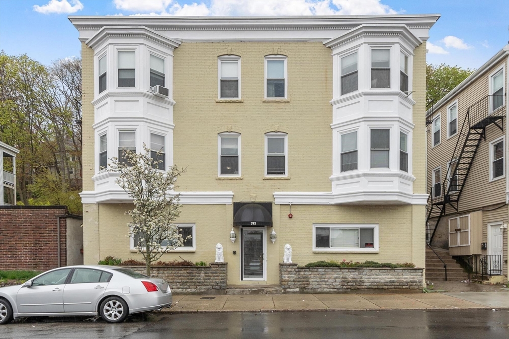 793 Main Street, Unit 1 Malden, MA 02148 - Photo 7 of 8 a front view of a residential apartment building with a yard