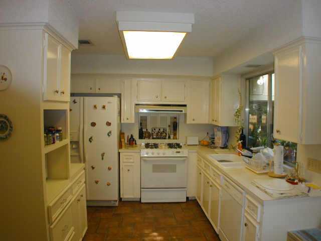 a kitchen with a sink stove and refrigerator