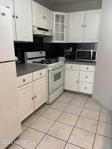 a kitchen with appliances cabinets and a window