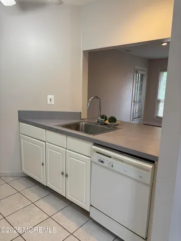 a sink with white cabinets