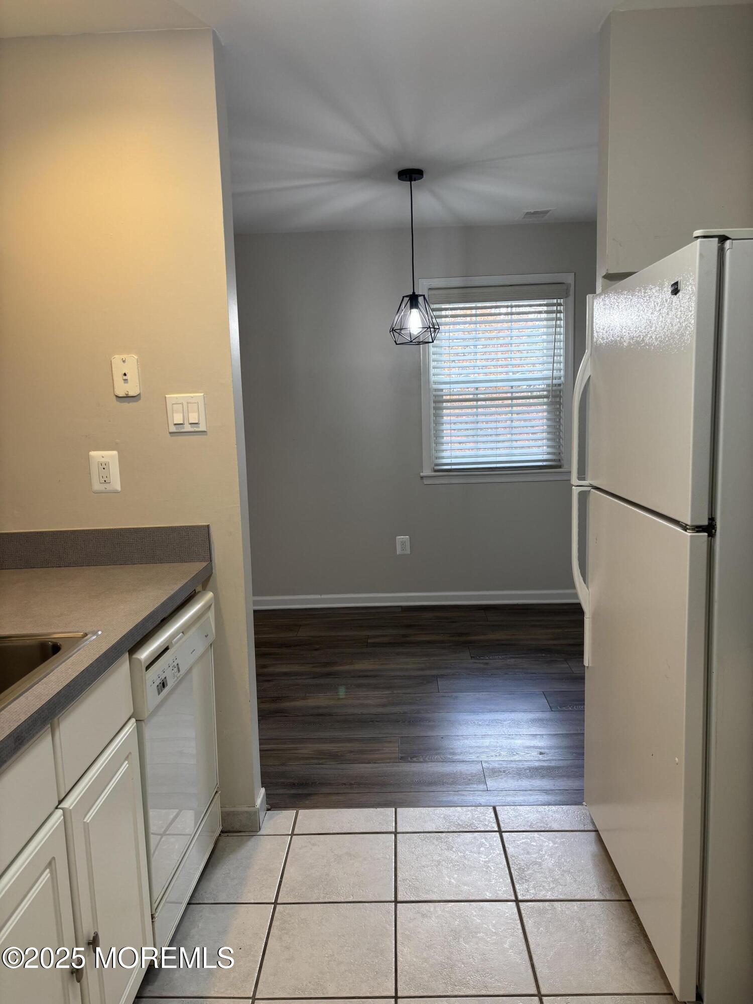 481 Hawthorne Place Morganville, NJ 07751 - Photo 21 of 36 a view of a refrigerator in kitchen and an empty room