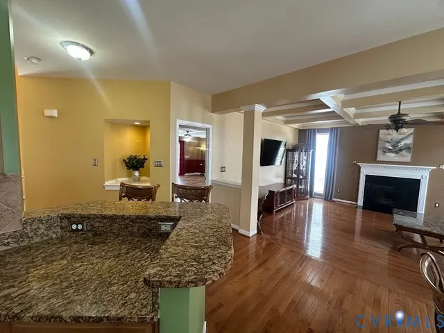 a kitchen with a dining table chairs and refrigerator