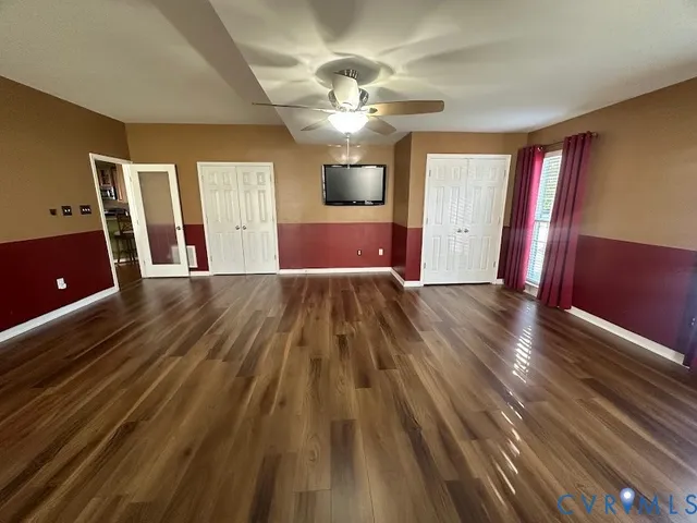 a spacious bedroom with a bed and a chandelier