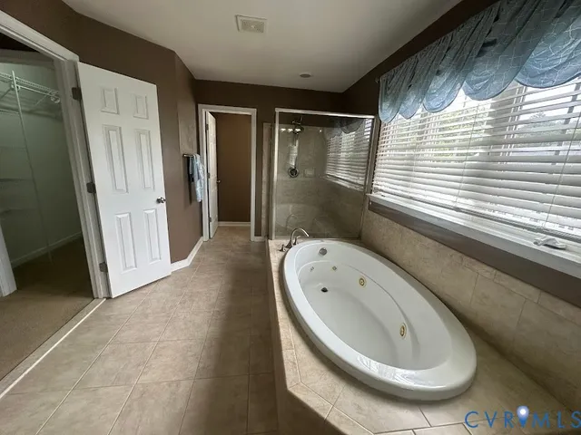 an empty room with chandelier fan