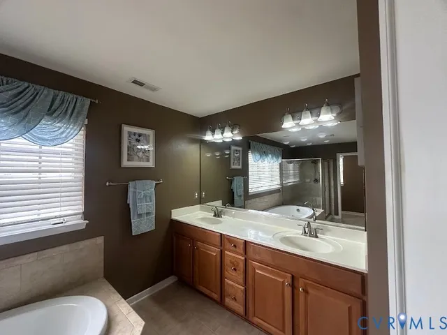 a bedroom with a bed dresser and a window