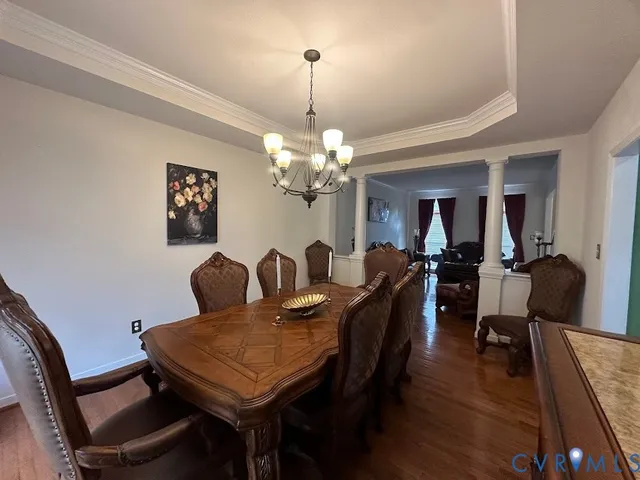 a view of a dining room with furniture and wooden floor