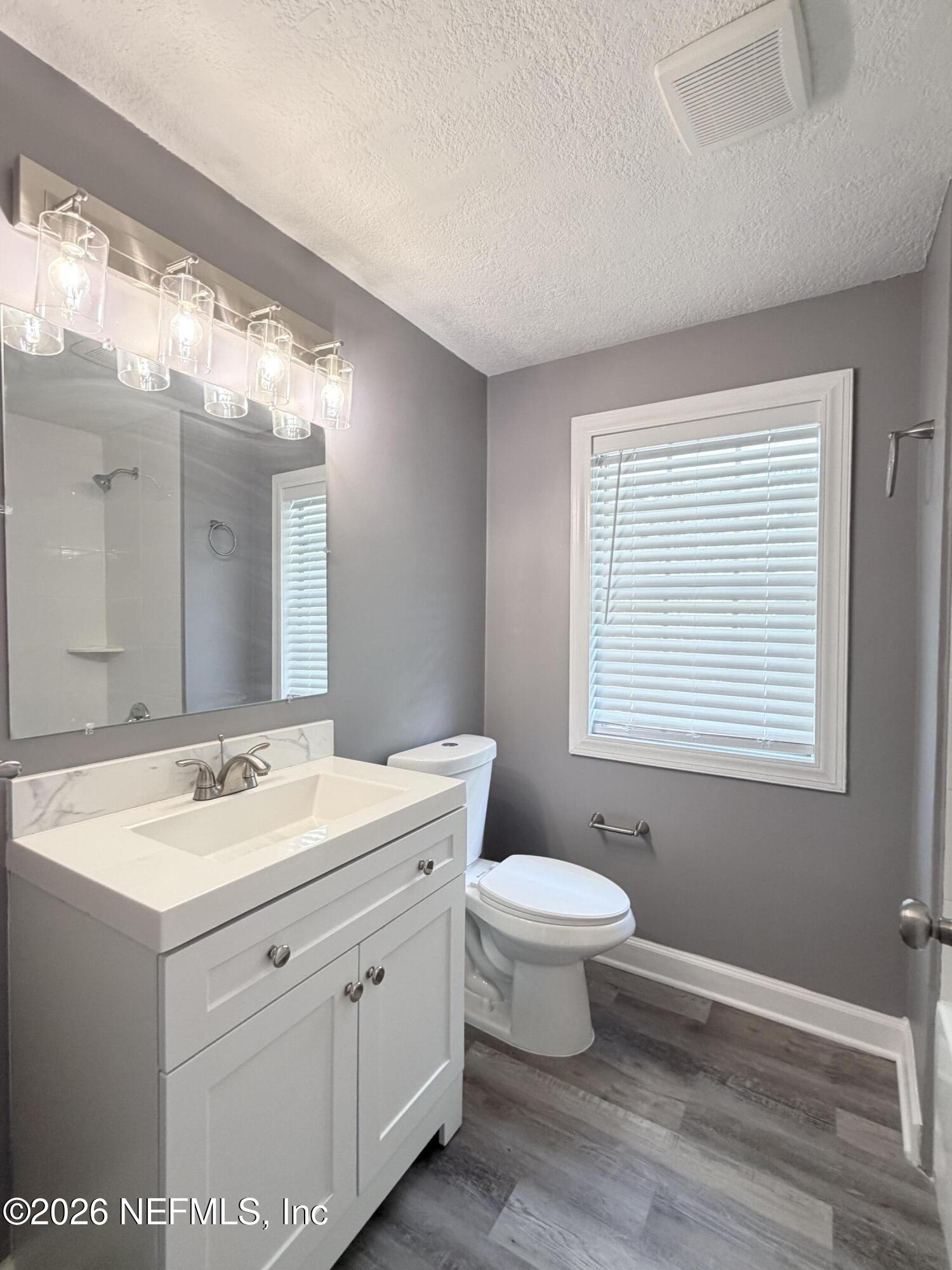 5336 Cruz Road Jacksonville, FL 32207 - Photo 18 of 29 a bathroom with a toilet sink and mirror