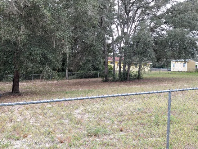 a view of a yard with a trees