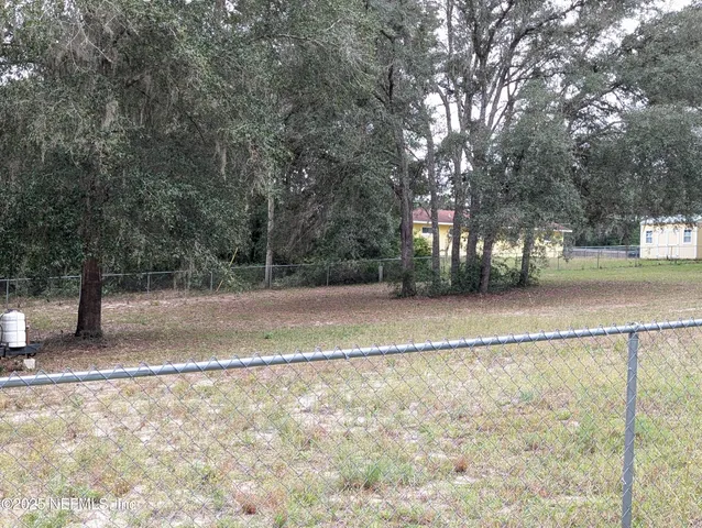 a view of backyard with green space