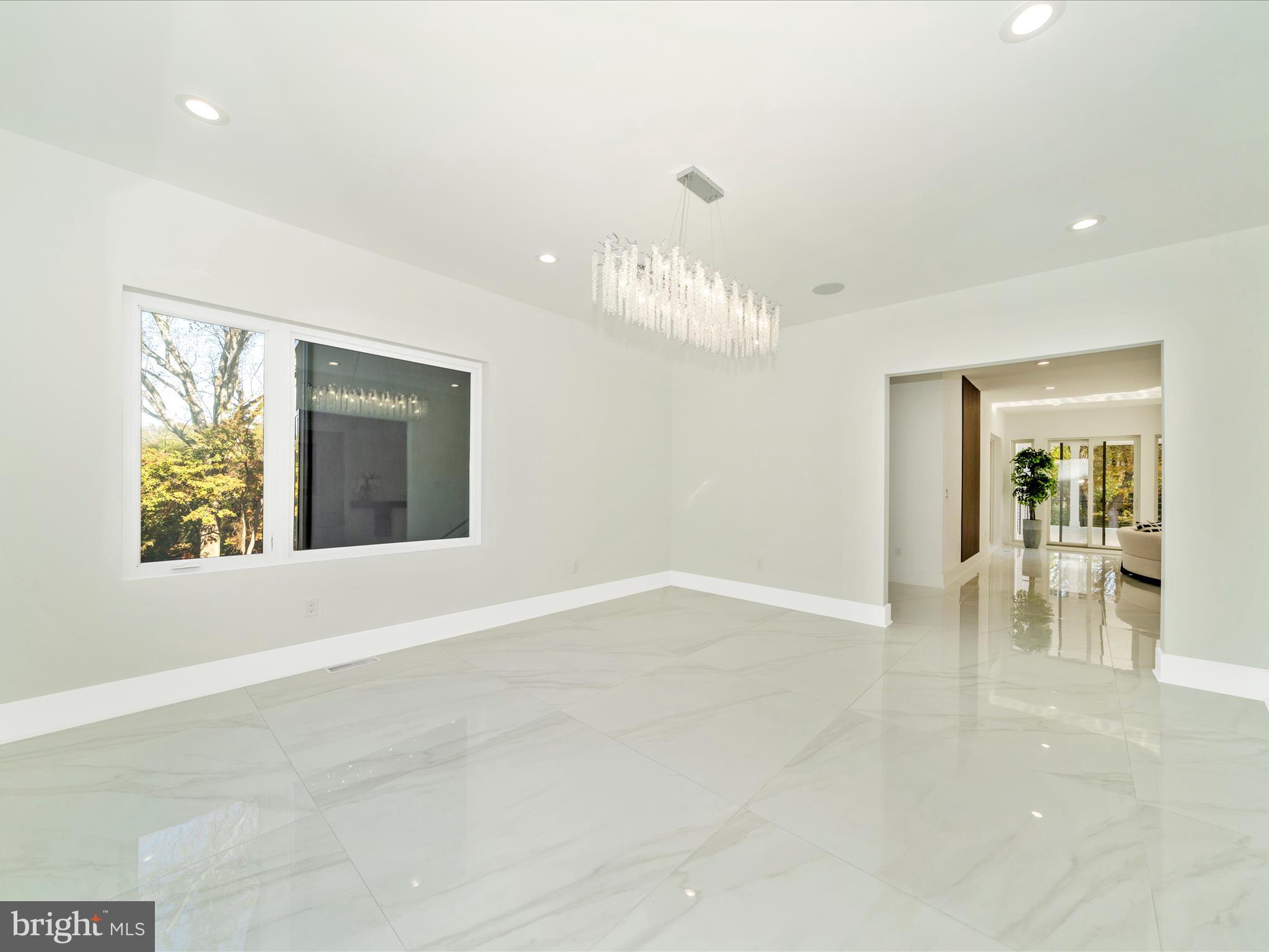 2209 Hunter Mill Road Vienna, VA 22181 - Photo 13 of 102 an empty room with windows and chandelier