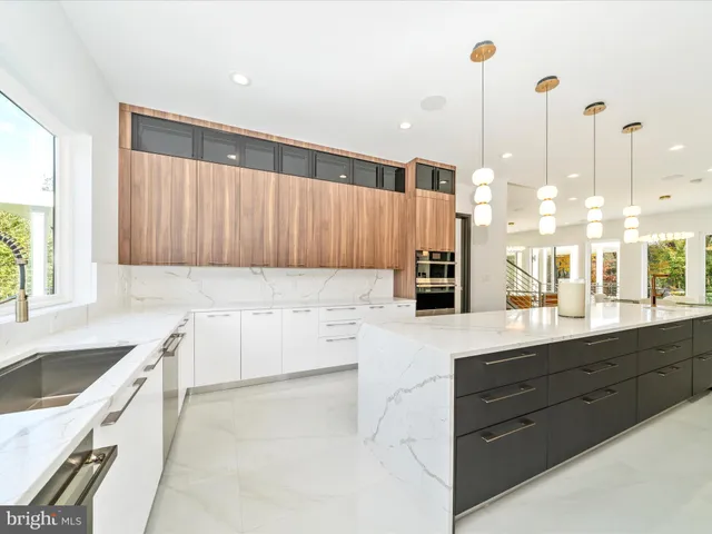 a bathroom with a double vanity sink mirror and bathtub