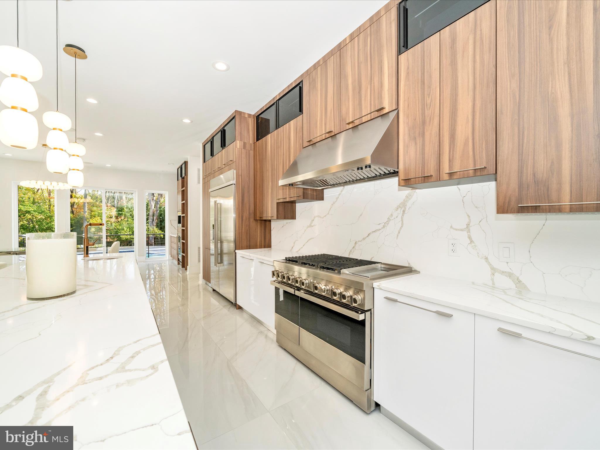 2209 Hunter Mill Road Vienna, VA 22181 - Photo 26 of 102 a kitchen with stainless steel appliances granite countertop a stove a sink and a refrigerator